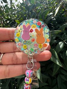 This bold and bright badge reel cutie is showing off those little peep Easter bunnies in such a bold way!  These make super fun and useful gifts for any person in any profession. A great gift choice for nurses, medical staff, office staff, and anyone who is required to wear a badge. Hand made with glitter, resin, and design printed to make it waterproof. Each design is handmade so each badge we make will look slightly different than the next.  Indoor and outdoor photos to show details.  TERMS AN Fun Pink Badge Reel For Gift, Personalized Fun Badge Reel For Gift, Fun Pink Badge Holders For Gift, Personalized Fun Badge Reel Gift, Cute Personalized Badge Reel For Gifts, Personalized Cute Badge Reel For Gift, Playful Multicolor Badge Reel For Gifts, Novelty Multicolor Badge Reel For Hobby, Playful Multicolor Badge Holders For Gift