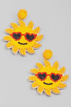 two yellow and black beaded sunflowers with sunglasses on each ear, one is wearing