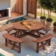 a wooden picnic table sitting next to a swimming pool with bread on top of it