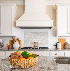 a basket full of fruit sitting on top of a kitchen counter next to an oven