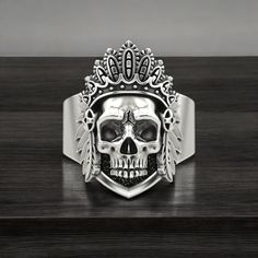 Celebrate the rich cultural heritage and powerful symbolism with our Indian Skull Ring, crafted from high-quality 925 Sterling Silver. This striking ring features an intricately detailed Indian skull design, representing strength, resilience, and ancestral heritage. Each piece is meticulously handmade, showcasing exceptional craftsmanship and attention to detail, ensuring every ring is unique and of the highest quality. Perfect for both men and women, this statement ring adds a touch of cultural Silver Symbolic Skull Ring, Symbolic Silver Skull Ring, Symbolic Engraved White Gold Skull Ring, Silver Oxidized Skull Ring, Spiritual Silver Engraved Skull Ring, Ceremonial Hallmarked Jewelry, Women Symbol, Indian Skull, Symbol Of Strength