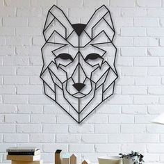 a metal wall sculpture depicting a wolf's head on a white brick wall in front of a table