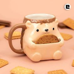 a mug with a bear in it is surrounded by crackers