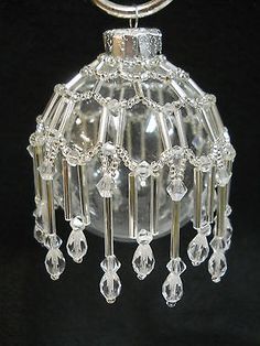 a clear glass beaded hanging ornament on a metal ring with an acrylic handle