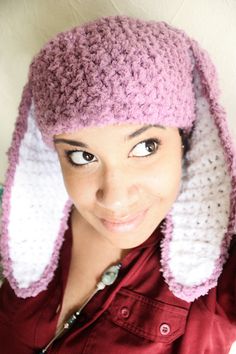 a woman wearing a crocheted bunny hat