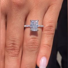 a woman's hand with a ring on it and a diamond in the middle