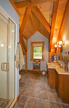 a bathroom with a walk in shower next to a sink