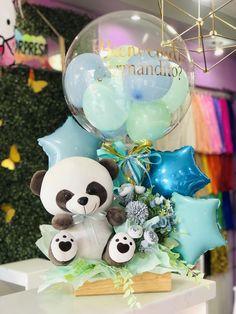 a panda bear balloon and some balloons on a table