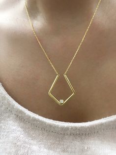 To give a dainty meaningful gift for your loved one you can prefer this geometric ring holder necklace. Or this 8K plain gold ring keeper necklace can be a special treat just for yourself . You can prefer any colour of birthstone on this custom birthstone ring holder necklace. This solid gold geometric pendant jewelry is the best way to present your ring in a safe and expressive manner. *FEATURES We are using real gold in our product for pendant and chain .  Material : 8K Solid Gold  Pendant width : 2.2 cm Pendant length : 2.6 cm Colour : gold  Chain Length : 14''-20'' upon your request  The open necklace laid straight & measured end to end. * PACKAGING Jewels will be sent nicely wrapped and packed in a box! If specific goods are intended as gifts, please leave us a note. We'll use a speci Modern 14k Gold Jewelry With Single Diamond, Gift Diamond-shaped Necklace With Single Diamond, Modern Gold Jewelry With Bezel Setting, Minimalist Jewelry With Bezel Setting In Recycled Gold, Recycled Gold Jewelry With Single Diamond As Gift, Gift Jewelry With Single Diamond In Recycled Gold, Single Diamond Jewelry In Recycled Gold As A Gift, Minimalist Pendant Jewelry With Bezel Setting, Minimalist Recycled Gold Jewelry With Diamond Cut