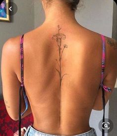 a woman with a flower tattoo on her back