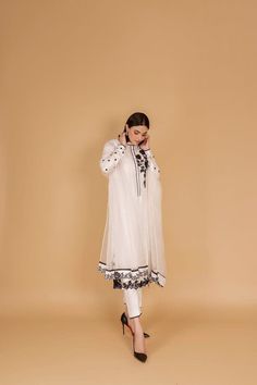 Introducing our sophisticated off-white silk kurta pant set, a timeless ensemble that seamlessly blends traditional elegance with contemporary style. Crafted with care, this outfit is perfect for occasions that demand grace and poise. The off-white silk kurta features a classic silhouette, providing both comfort and style. The intricate embellishments in black resham thread add a touch of sophistication, creating a beautiful contrast against the serene backdrop of the fabric. The careful detailing showcases skilled craftsmanship, making this ensemble a true work of art. Paired with the kurta are comfortable and chic pants, completing the look with a modern twist. The flowing silhouette of the pants enhances the overall grace of the outfit, making it suitable for various occasions. To eleva Elegant Georgette Sherwani With Dupatta, Elegant Georgette Salwar Kameez For Traditional Ceremonies, Elegant Georgette Anarkali Set For Traditional Ceremonies, Elegant Georgette Sherwani With Resham Embroidery, Elegant Georgette Sherwani For Eid, Traditional Dabka Palazzo Set For Eid, Elegant Palazzo Set For Diwali Ceremonies, Elegant Palazzo Set For Diwali And Traditional Ceremonies, Eid Palazzo Set With Dabka For Traditional Ceremonies