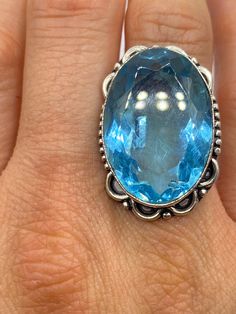 Large genuine aqua blue volcanic art glass Vintage ring Low content silver not sterling. Size 8 Our jeweler can re size this for a 20 fee.  All rings are shipped in a nice gift box.   Check out our over a THOUSAND great reviews Engraving is $4 per letter and is not always perfect depending on the piece. It can take a few days if the jeweler is busy. This is payable to Paypal Judithsltd@gmail.com Spiritual Blue Topaz Jewelry In Blue, Spiritual Round Blue Topaz Jewelry, Spiritual Blue Crystal Gemstone Ring, Spiritual Blue Crystal Ring, Turquoise Ring With Accent Stones For Gift, Silver Oval Topaz Ring Gift, Handmade Silver Turquoise Ring For Formal Occasions, Collectible Blue Rings, Sterling Silver Turquoise Ring With Accent Stones As Gift