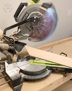 a circular saw is being used to cut wood with a mitt and other tools