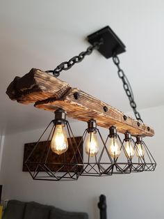 the light fixture is made out of wood and has five bulbs hanging from it's chain