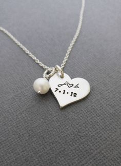 "« Personalized Necklace with Initials and Date // Anniversary Necklace // Hand Stamped Jewelry // Hand Stamped Necklace » Have this pretty heart pendant hand stamped with the initials and date of your choice to make the perfect gift! This necklace makes such a cute gift or keepsake and a cute way to carry a meaningful part of your life with you. The 3/4\" heart and freshwater pearl are hung from an 18\" oval link chain. Please let me know in the 'note to seller' box during checkout with the ini Personalized Heart Pendant Necklace For Wedding, Personalized Pendant Heart Necklace For Wedding, Meaningful Heart-shaped Wedding Jewelry, Personalized Heart Pendant Charm Necklace For Wedding, Personalized White Heart Necklace For Wedding, Wedding Personalized Heart Pendant Charm Necklace, Personalized Heart Charm Necklaces For Wedding, Silver Hand Stamped Heart Necklace For Anniversary, Dainty Stamped Charm Necklaces For Anniversary