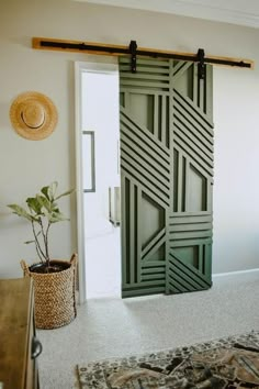 a room with a bed, rug and sliding door that has an abstract design on it