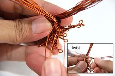 someone is working with copper wire to make an ornament for a flower arrangement