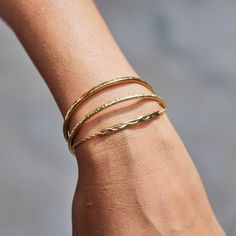 This bar bracelet features a unique, gentle texture, capturing the ripples of flowing water in lush, polished gold. We created ripple like textures textures, adapted to the individual pieces that are soft and sleek, with very gentle ups and downs, that flow with the golden surface like the movements of water. The Bracelet can be adjusted to a variety of wrist sizes. This piece is made from Sterling Silver and plated with a thick layer of 18ct solid gold. Store your jewellery in a protective box Thick Gold Bracelet, Flowing Water, Bar Bracelet, August Birthstone Jewelry, July Birthstone Jewelry, Bristle Brush, Gold Bracelet Cuff, Jewelry Ring Box, Bar Bracelets