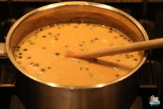 a wooden spoon in a pot on the stove