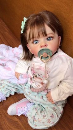 a baby doll with a pacifier in her mouth