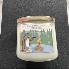 there is a candle that has a penguin on it and fire in front of it