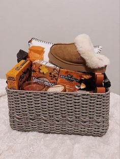 a basket filled with items sitting on top of a bed