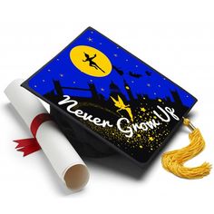 a graduation cap with the words never grow up on it and a tassel next to it