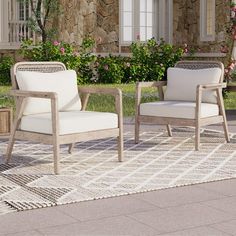 two white chairs sitting on top of a rug