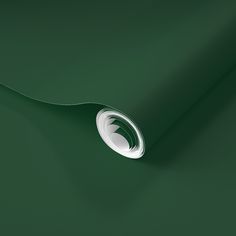 a roll of dark green paper with a white circle on the bottom and an arrow in the middle