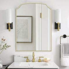 a bathroom with a sink, mirror and towel rack on the wall next to it