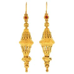 Circa 1820-80s, 22k+, India. These 19th-century high karat gold Mogul earrings have it all, superb details, dramatic length, warm patina, lovely rubies and a look that is glamorously everything Boho wanted to be when it grew up. Made in the late 1800s from Mogul elements circa's 1820, 1840 and 1880, a fashion mad genius must have conceived the design as they are simply one of the most fabulous pair of earrings I have ever seen! Very good condition. Remark: "When you look up Bohemian earrings tha