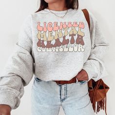 This cozy LMHC Therapist sweatshirt is a perfect fit for the therapist who loves to lounge around in it or wear around the office. This crewneck sweater has a simple, but meaningful message: "I'm a mental health therapist, and I care. You can too." Note: ♡ Our products are made to order specially for you. We have included size charts and a quick memo on finding the perfect size!  ♡ We don't accept returns or exchanges. Please check our color and size charts before you place your order :) ♡ Pleas Crew Neck Cotton Sweatshirt For Relaxation, Cotton Crew Neck Sweatshirt For Relaxation, Cotton Graphic Print Tops For Lounging, Crew Neck Top With Graphic Print For Relaxation, Graphic Print Crew Neck Tops For Relaxation, Relaxed Fit Graphic Print Top For Lounging, Relaxation Graphic Print Crew Neck Top, Casual Tops With Letter Print For Lounging, Graphic Print Crew Neck Top For Lounging