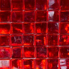 a close up shot of some red glass tiles that are very bright and shiny in color