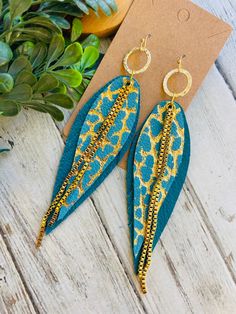 turquoise gold Leopard chain fringe feather ring earring/statement earring/long feather earring/large feather Leather earring/ooak  Perfect Flirty leopard statement earrings!  turquoise , turquoise  gold leopard  chain fring-y feather leather earrings Earrings are gold plated.So fun and boho -licious! Light weight and comfy. Earring hooks are lead and nickel free. Earrings are ready to sell and will ship out same or next day. Earrings come in a gift box ready for gifting with tracking .thank you Gold Feather Earrings For Party, Gold Feathered Jewelry For Parties, Trendy Fringe Jewelry Gift, Trendy Fringe Jewelry As Gift, Trendy Fringe Jewelry For Gifts, Trendy Fringed Jewelry As Gift, Bohemian Drop Earrings With Adjustable Chain, Gold Feather Earrings As A Gift, Gold Feather Earrings For Gift