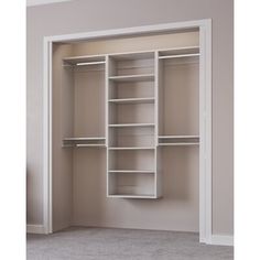 an empty closet with white shelves and carpeted flooring in the middle of it