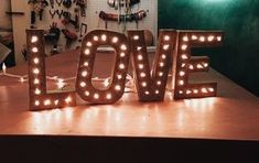 the word love spelled with lights on a table