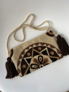 This is a handmade crochet pouch made by the Wayuu tribe from Colombia. Is one thread weaven, made with ancestral wisdom and special meaning. It looks so hippie chic and everyone will talk about it 100% COTTON directly from the Wayu' community in Guajira  Colombia, with your purchase, we help the Wayuu people to its development and evolution. Approximate dimensions: H: 5.5inch x W: 10.5inch. Straps approx. 22 Inches long Bohemian Crochet Pouch Bag For Festivals, Festival Handwoven Crochet Pouch Bag, Woven Crochet Pouch Bag For Festivals, Bohemian Crochet Pouch Bag For Daily Use, Festival Woven Crochet Pouch Bag, Bohemian Crochet Pouch Shoulder Bag, Brown Bohemian Crochet Bag For Festivals, Bohemian Brown Crochet Bag With Woven Details, Bohemian Woven Crochet Pouch Bag