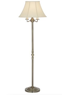 a floor lamp with a white shade on it's base and a light bulb in the middle