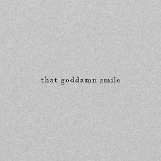 the words that godalam smile are written in black on a gray paper background