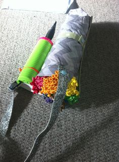 an umbrella is laying on the floor next to a bag