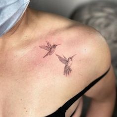 a woman's shoulder with two hummingbirds tattoo on her left shoulder and chest