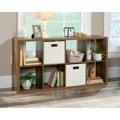 a shelf with baskets and books on it