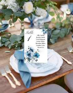 a table set with blue and white flowers