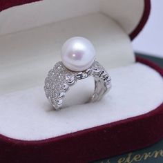 Looking for a timeless piece of pearl jewelry to add to your collection? House of Pearls’ 12-13mm Freshwater Pearl & Large Full CZ Wide Diamond Ring is the perfect classic addition. This ring offers a large 12-13mm freshwater pearl alongside a large full CZ diamond, making it wearable luxury. Celebrate your special moments by wearing this beautiful pearl & diamond ring. White 12-13mm Freshwater Pearl Ring This popular ring design features AAAA quality, round freshwater pearls measuring 12-13mm. Pearl White Diamond Pearl Ring With Drop Detail, Pearl White Diamond Ring With Pearl Drop, White Gold Pearl Ring With Pearl Drop, Elegant White Pearl Ring With Charm, Elegant White Gold Pearl Ring, Formal Open Pearl Ring, Elegant Pearl White Open Pearl Ring, Elegant Pearl White Open Ring, Silver Akoya Pearl Drop Ring