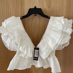 This Adorable Deep V Front And Back Ruffle Top Is New With Tags. Crisp White With Zipper Closure. White Ruffles Crop Top, Feminine Ruffled Crop Top For Brunch, White Cropped Ruffle Tops, White Ruffled Crop Top Blouse, Feminine Ruffled Crop Top For Vacation, Cropped Ruffle Blouse For Day Out, Cropped Ruffled Blouse For Day Out, Vacation Ruffle Crop Top, Vacation Ruffled Crop Top