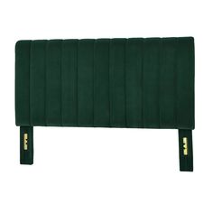 an upholstered headboard in green fabric with gold buttons on the bottom and sides