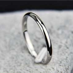 a silver ring sitting on top of a white cloth