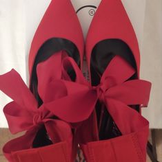 Elevate Your Style With These Striking Red Satin Pumps. The Pointed Toe And High Stiletto Heel Add A Touch Of Elegance, While The Ankle Ribbon Bow Tie Provides A Feminine Touch. These Pumps Are Perfect For Any Formal Occasion, Such As Weddings Or Business Events, As Well As Parties And Cocktails. Made From Synthetic Materials, These Stylish Pumps By Midnight Velvet, Are Both Durable And Comfortable. The Tie Closure Ensures A Secure Fit, While The Solid Accents On The Shoe Add A Pop Of Style. Ava Spring Heels With Red Bow, Evening Heels With Red Bow And Pointed Toe, Red Heels With Wrapped Heel And Ankle Strap, High Heels With Red Bow, Chic High Heels With Red Bow, Red Ankle Strap Heels For Evening, Red Heels With Wrapped Heel For Evening, Red Wrapped Heel Evening Heels, Red Wrapped Heel Heels For Evening