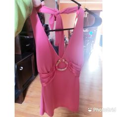 a pink dress hanging on a clothes rack