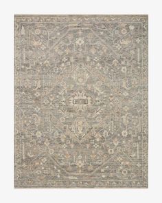 an antique style rug in grey and beige tones